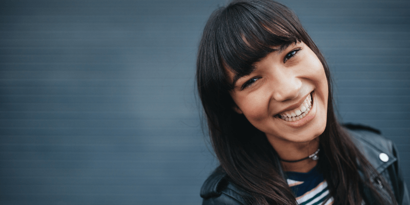 Woman smiling—Do guys like when girls text first