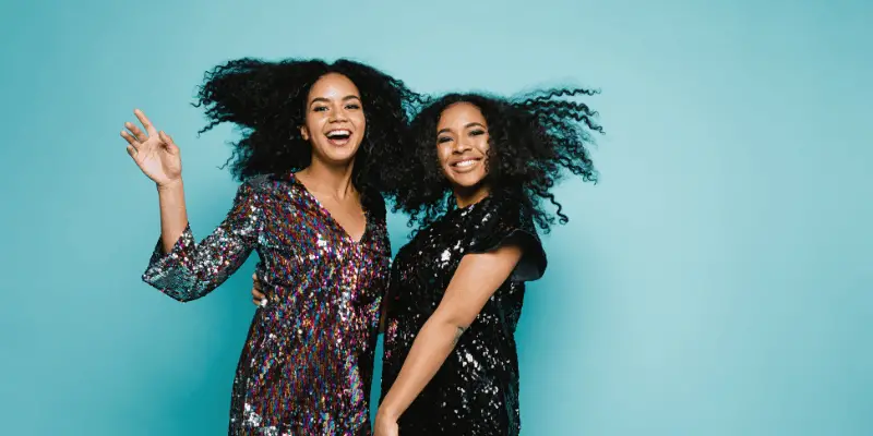 Two black girls smiling—Does dating help you move on