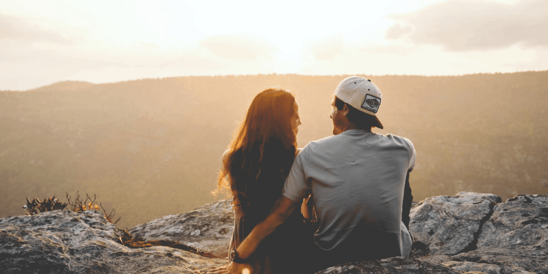 Couple sitting and looking over the horizon—Is Dating For a Year a Long Time